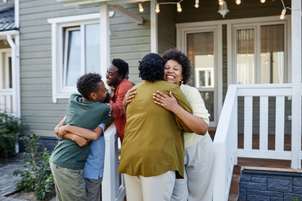 big-african-american-family-embracing-outdoors-welcoming-guests-housewarming-party